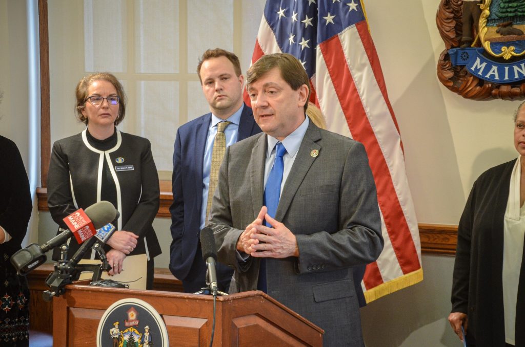 Troy speaking at a podium