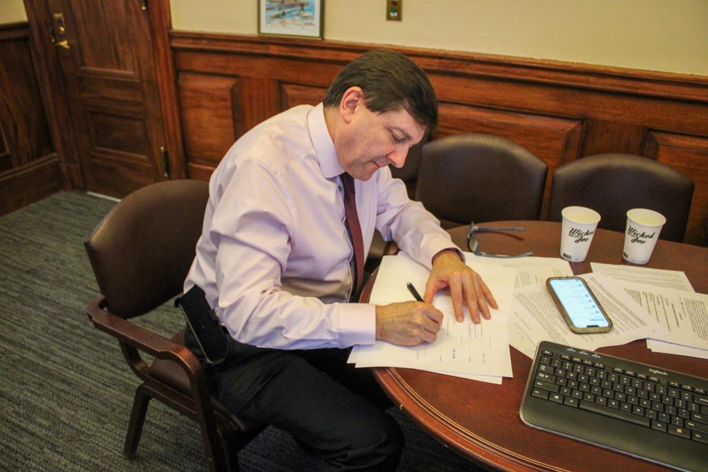 Troy signs legislation in his office